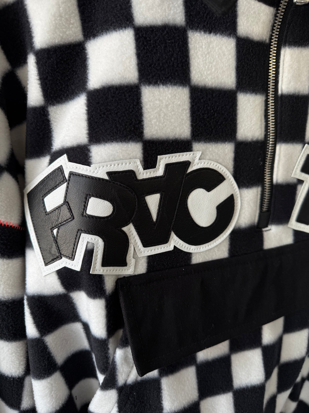 Layered black-and-white FRACTION leather lettering on checkerboard textile